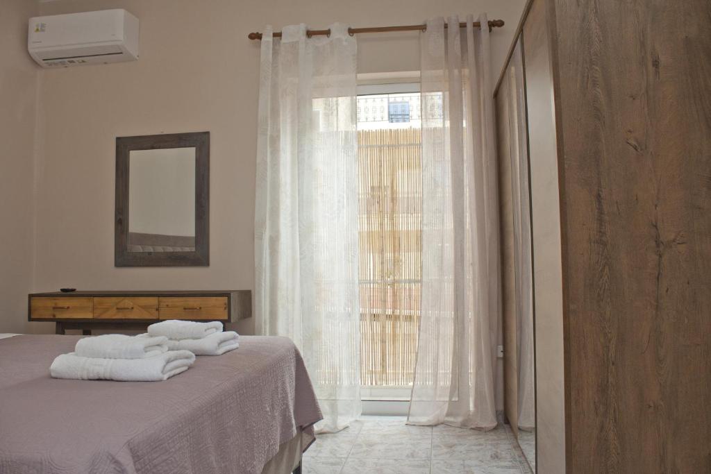 Postel nebo postele na pokoji v ubytování Danaos Hotel