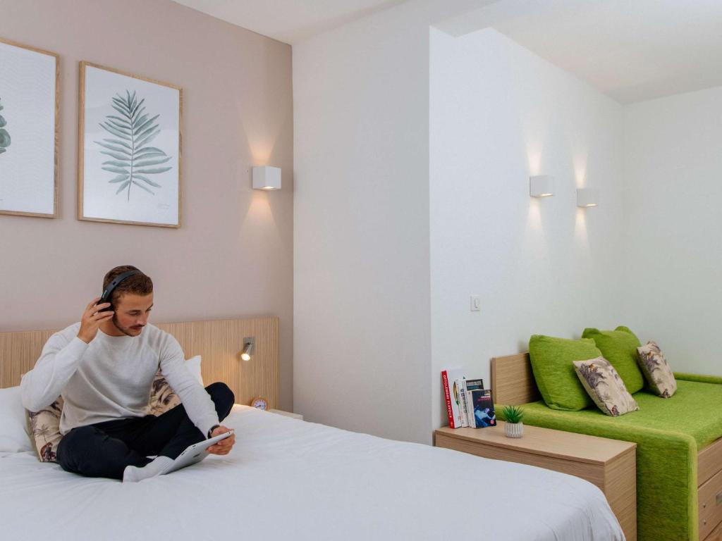 Postel nebo postele na pokoji v ubytování Aparthotel Adagio Access Bruxelles Europe Aparthotel