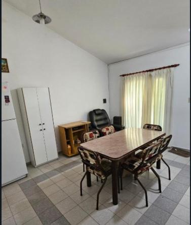 a kitchen with a table and chairs and a refrigerator at Apart More in Villa Mercedes