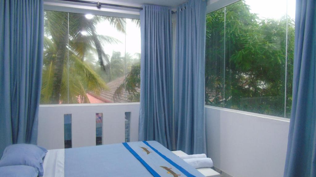 Postel nebo postele na pokoji v ubytování Ro Rich Hotel