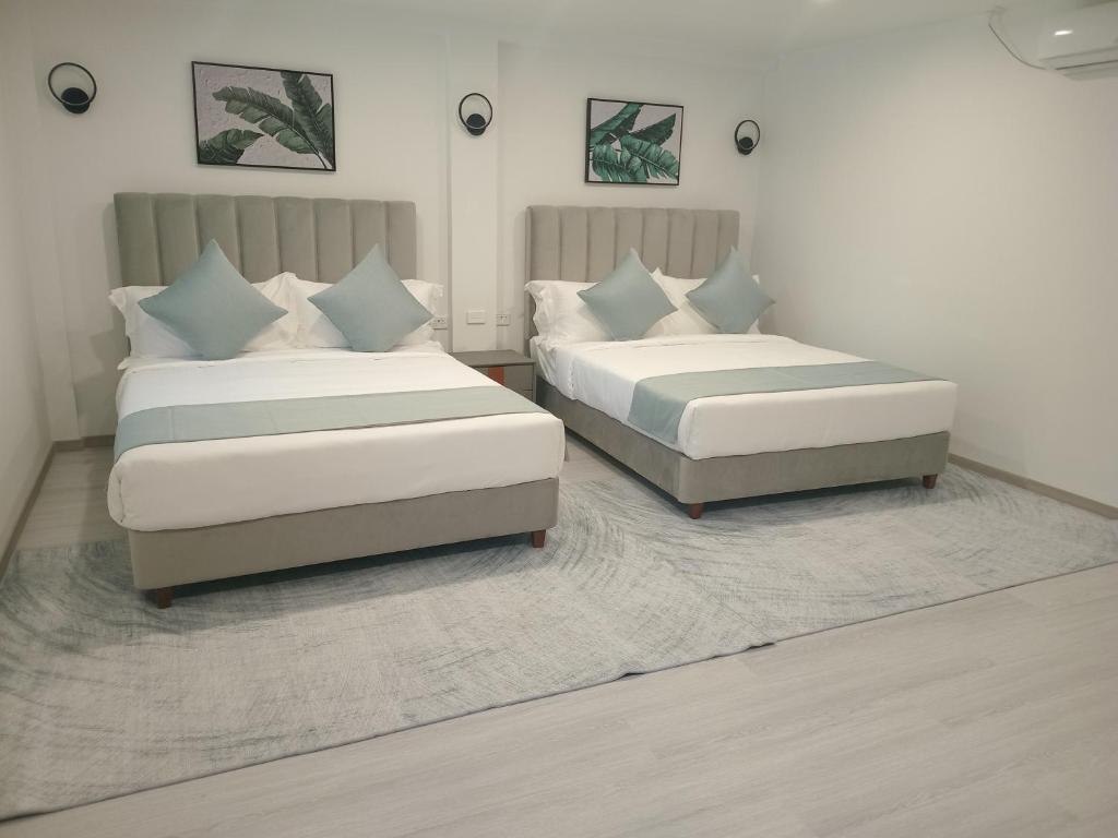 Letto o letti in una camera di Hibiscus Suites And Residences