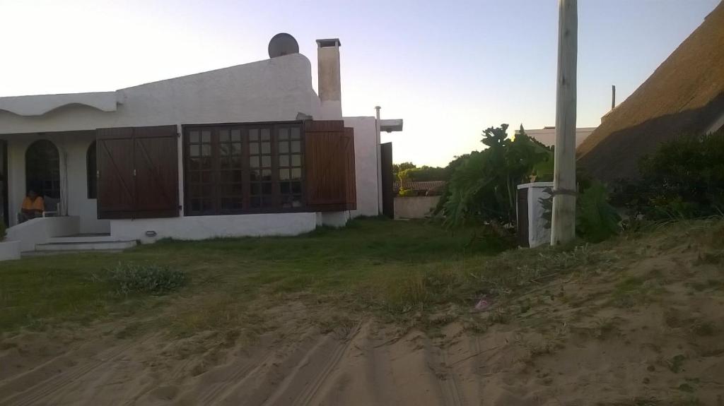 a house on the side of a dirt road at Balconada in La Paloma