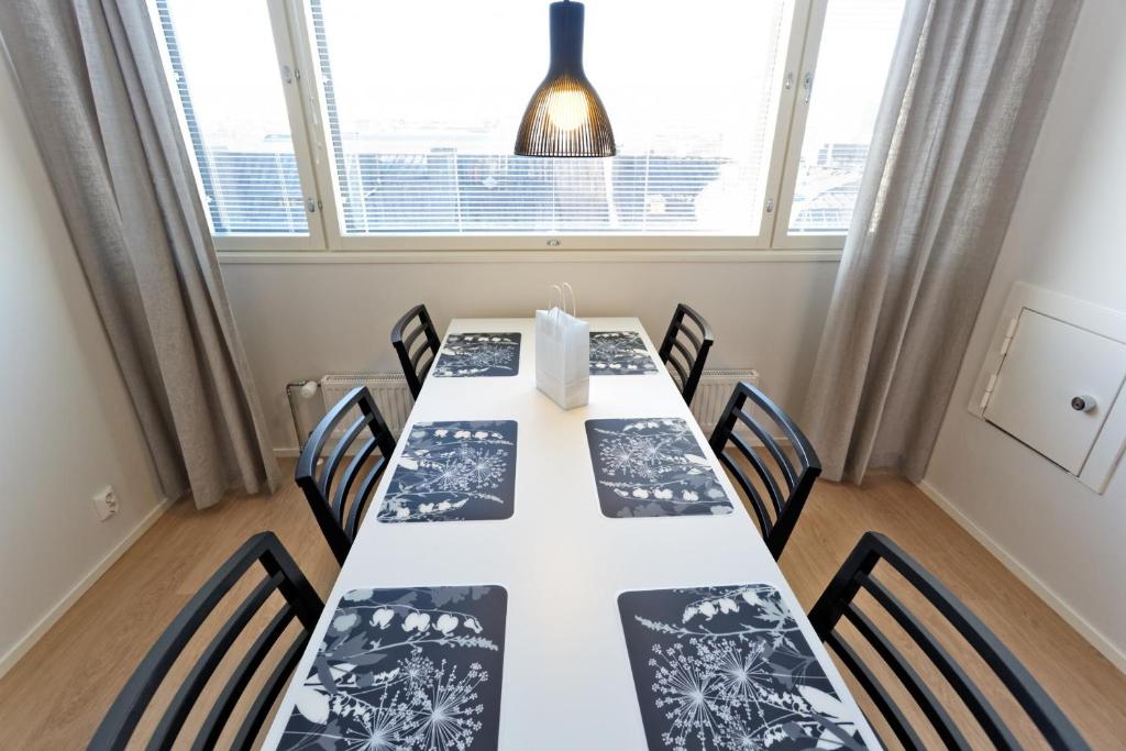 a conference room with a long table with chairs at Forenom Serviced Apartments Helsinki Kruununhaka in Helsinki