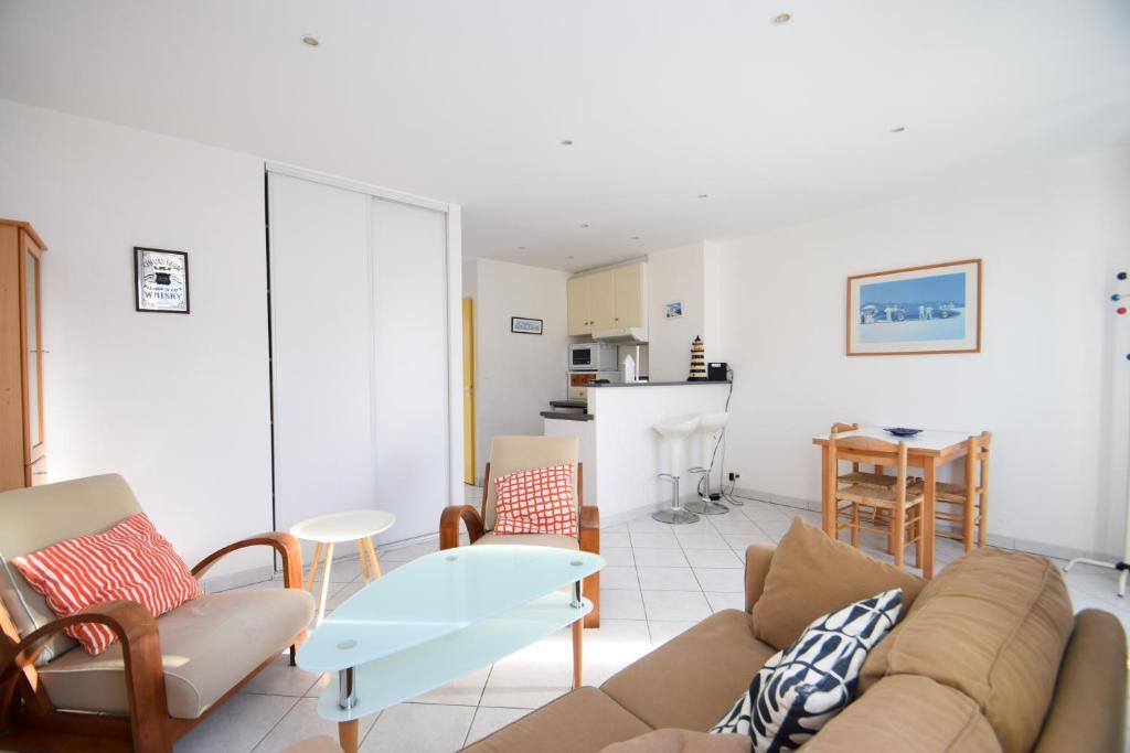un salon avec un canapé et une table dans l'établissement Appt 2 pièces confort 3 pers au pied de la plage vacances sans voiture, à Dinard