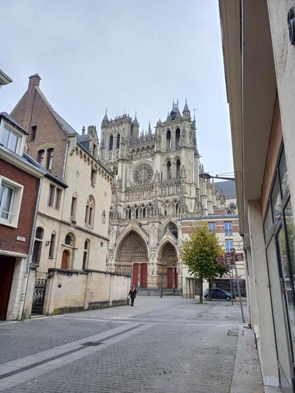 a building with a cathedral in the middle of a street at Plein centre- 90m Cathédrale - 2ch - 4 couchages - 6 personnes in Amiens