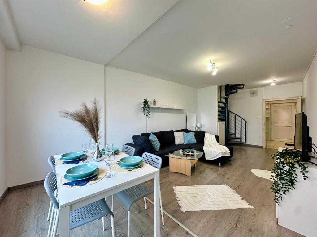 a living room with a white table and chairs at FREE PARKING - Stargate Budapest in Budapest