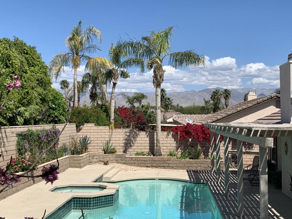 a swimming pool in a yard with palm trees at Tranquil 3BR Home w Private Pool Spa in La Quinta