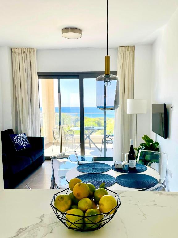 a bowl of fruit on a table in a living room at Coral Bay Garden in Peyia