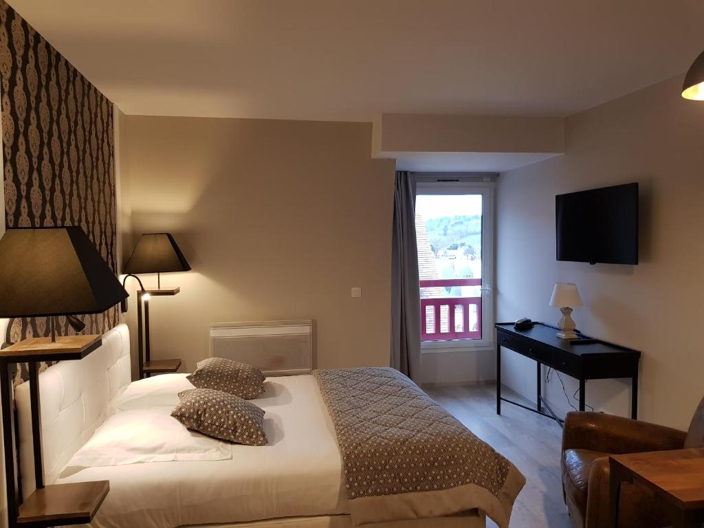 a hotel room with a bed and a window at Le Trophée Boutique Hôtel Spa- La Loggia Appart'hôtel in Deauville