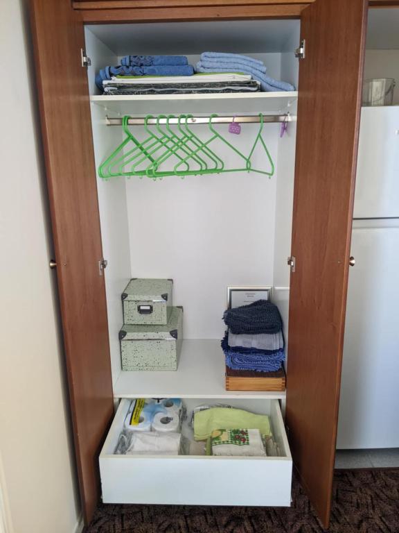 otwarta szafa z wieloma rzeczami w niej w obiekcie Small House for Holidays w mieście Leonidion