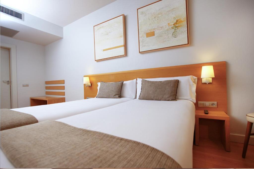 a bedroom with a large white bed in a room at Arc La Rambla in Barcelona