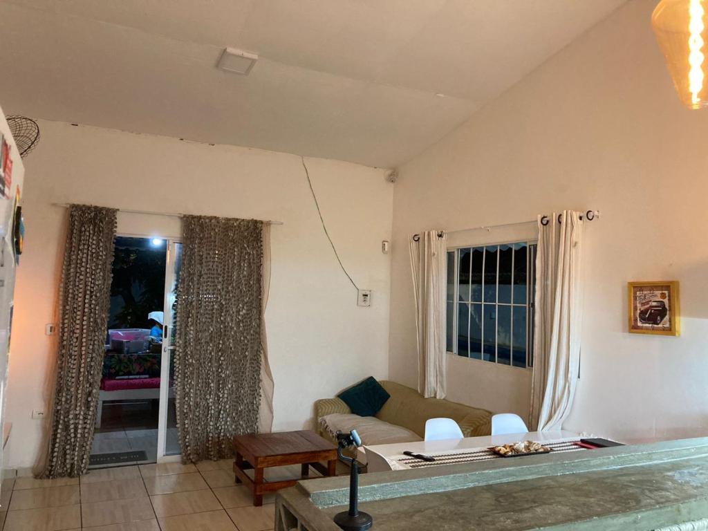a living room with a couch and a table at Casa em Porto de Galinhas in Porto De Galinhas