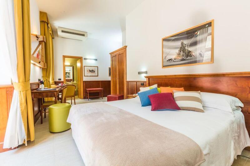Postel nebo postele na pokoji v ubytování Hotel Duomo