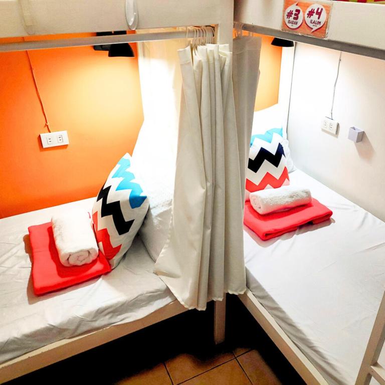 a bunk bed with two pillows on it at Crossroads Hostel Manila in Manila