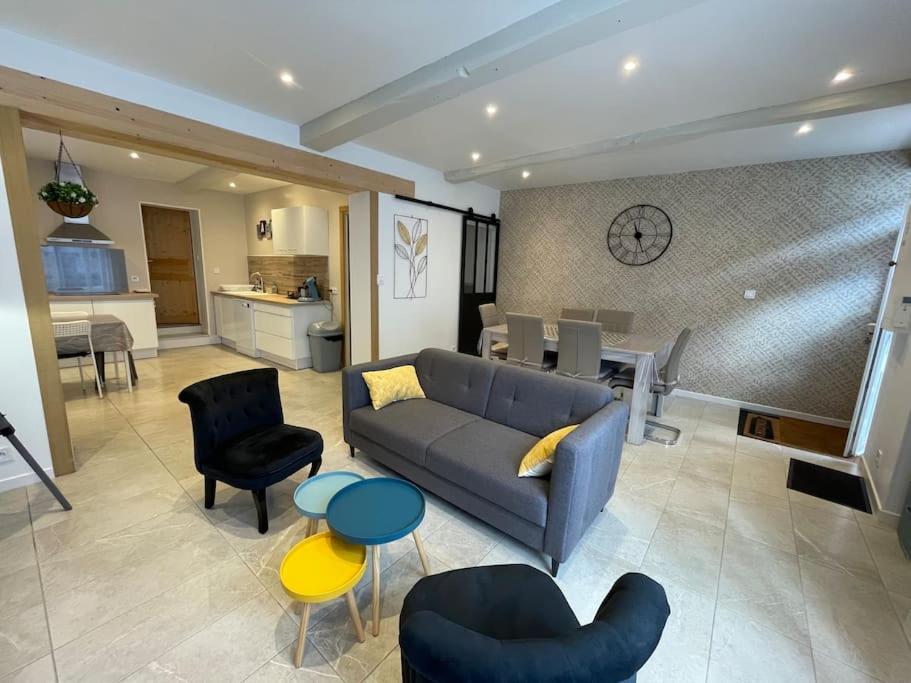 un salon avec un canapé et des chaises et une cuisine dans l'établissement Maison de Village, 3 chambres, fibre, à Dunes