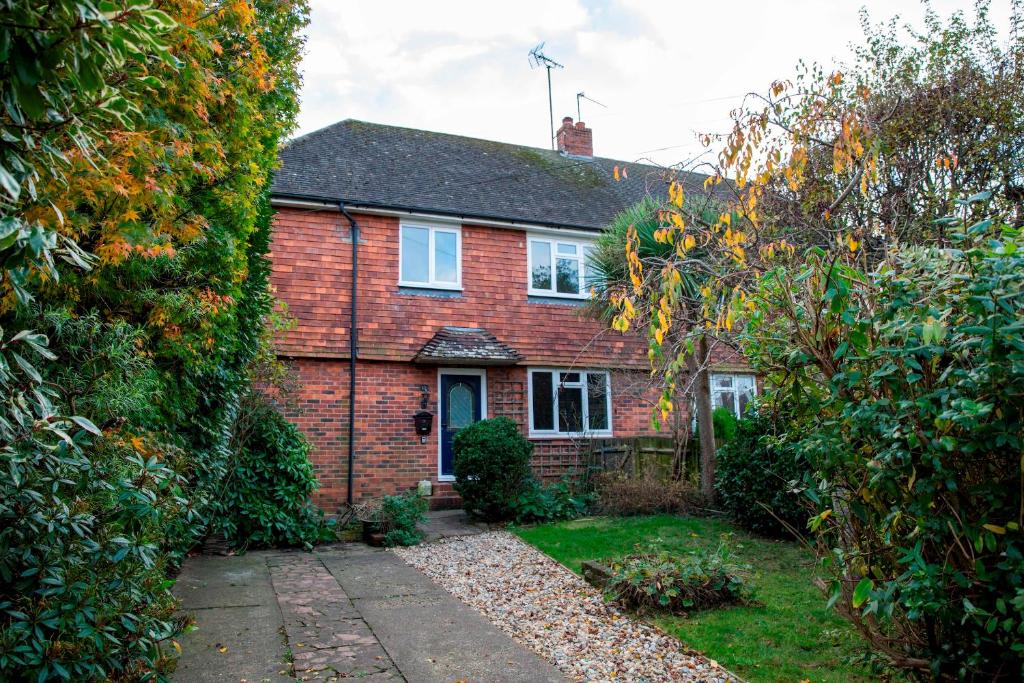 a red brick house with a garden in front of it at Hassocks Hideaway with Parking Garden in Hassocks