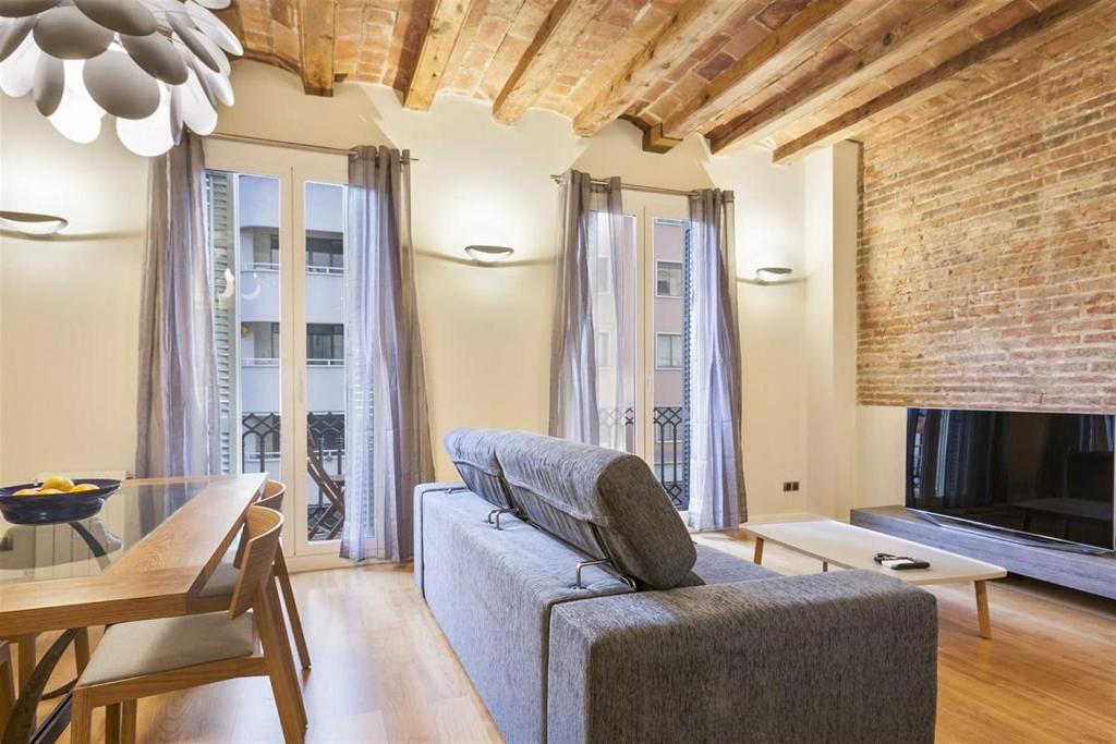 een woonkamer met een bank en een tafel bij Alcam Trafalgar in Barcelona