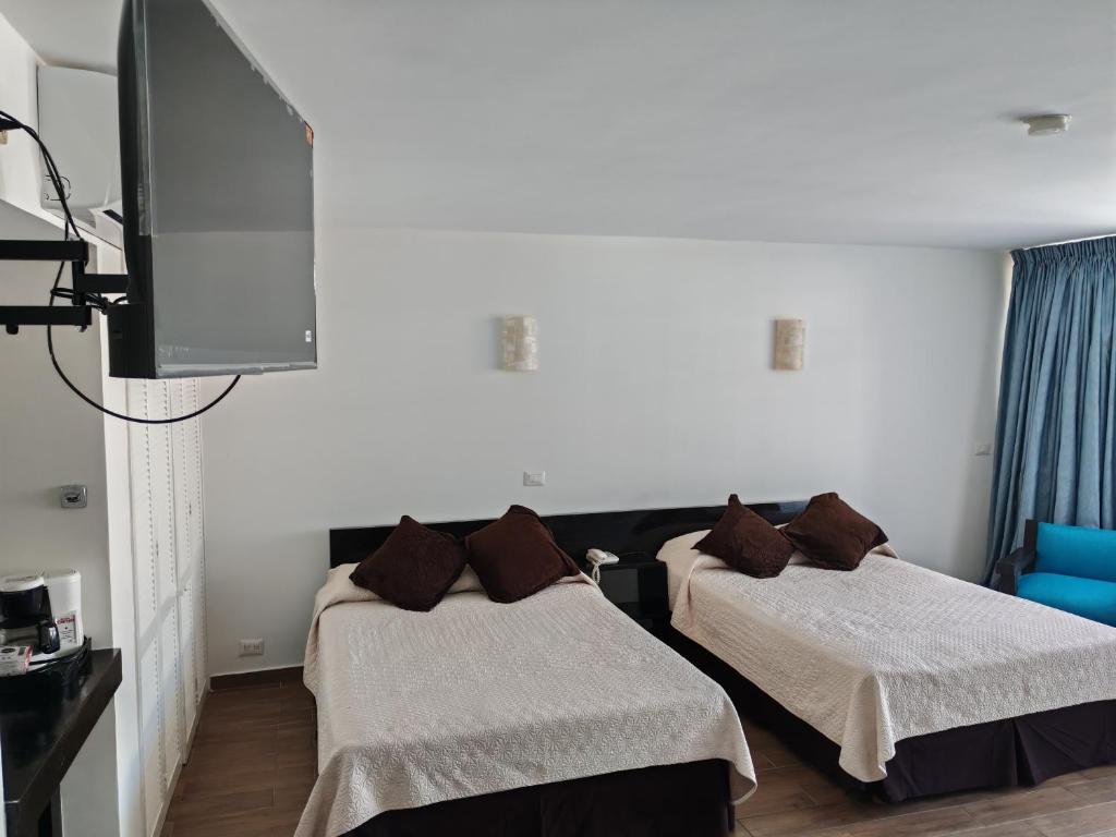 Postel nebo postele na pokoji v ubytování Gran Hotel Xalapa