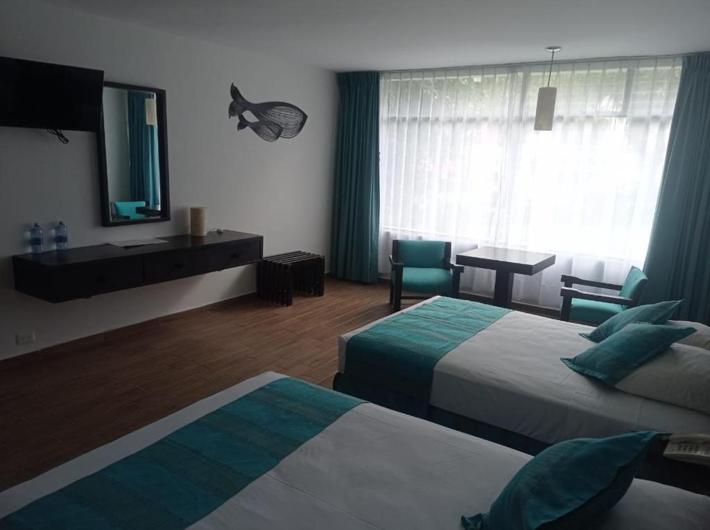 Postel nebo postele na pokoji v ubytování Gran Hotel Xalapa