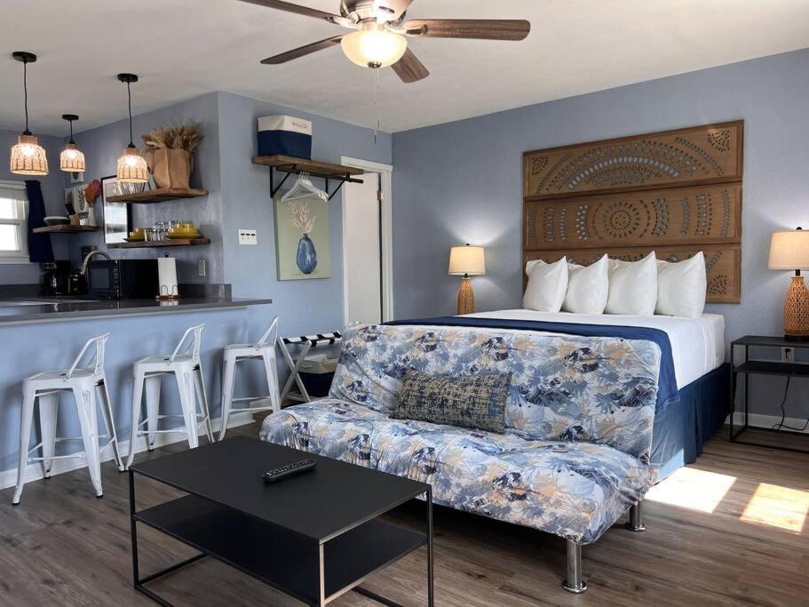a bedroom with a bed and a couch and a kitchen at The Mark at Surfside #6 in Surfside Beach