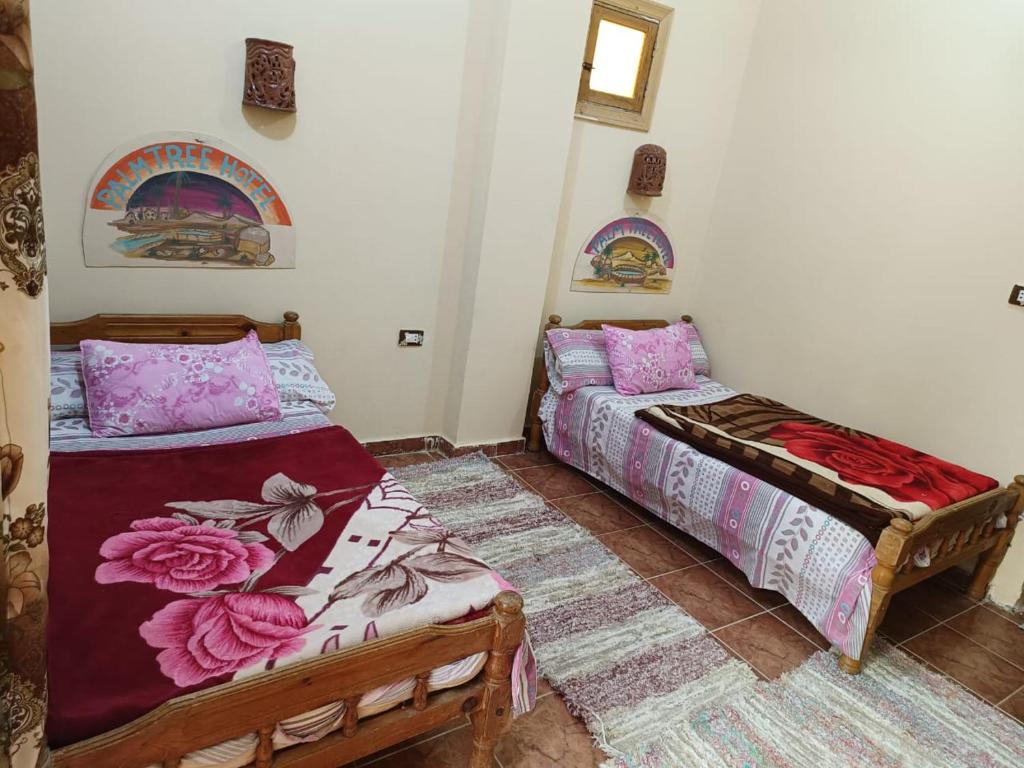 Postel nebo postele na pokoji v ubytování فندق النخيل