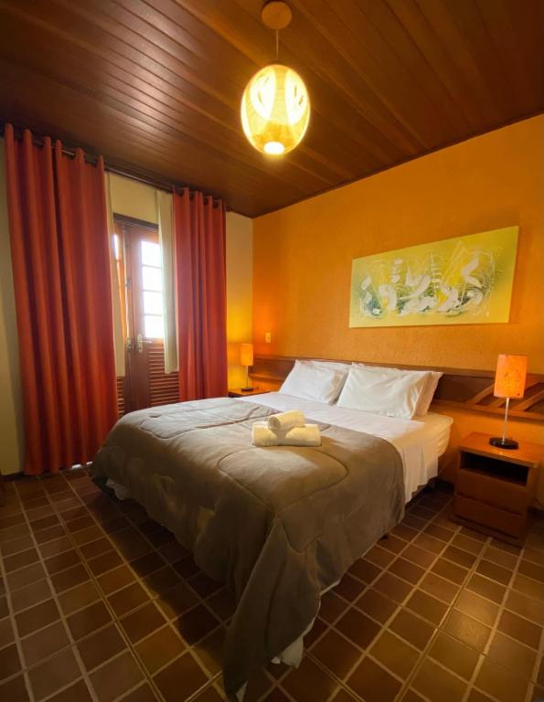 a bedroom with a large bed in a room at Villa Zen Pirenópolis Conforto e Bem-Estar in Pirenópolis