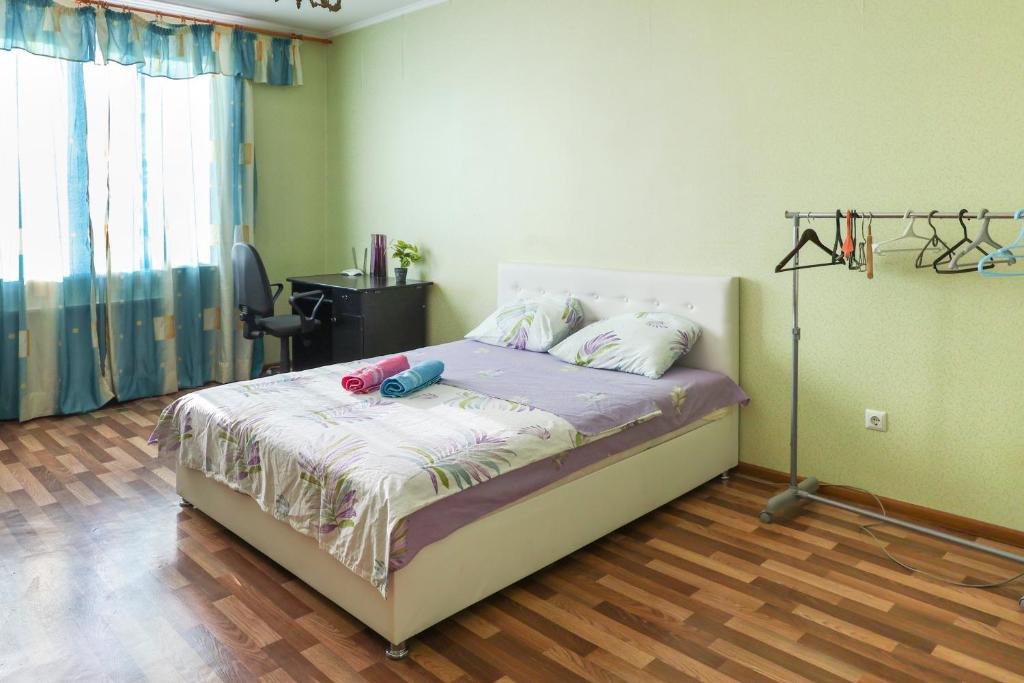 a bedroom with a bed with a lamp and a desk at Квартира в ЖК Сосновий Бір in Kyiv