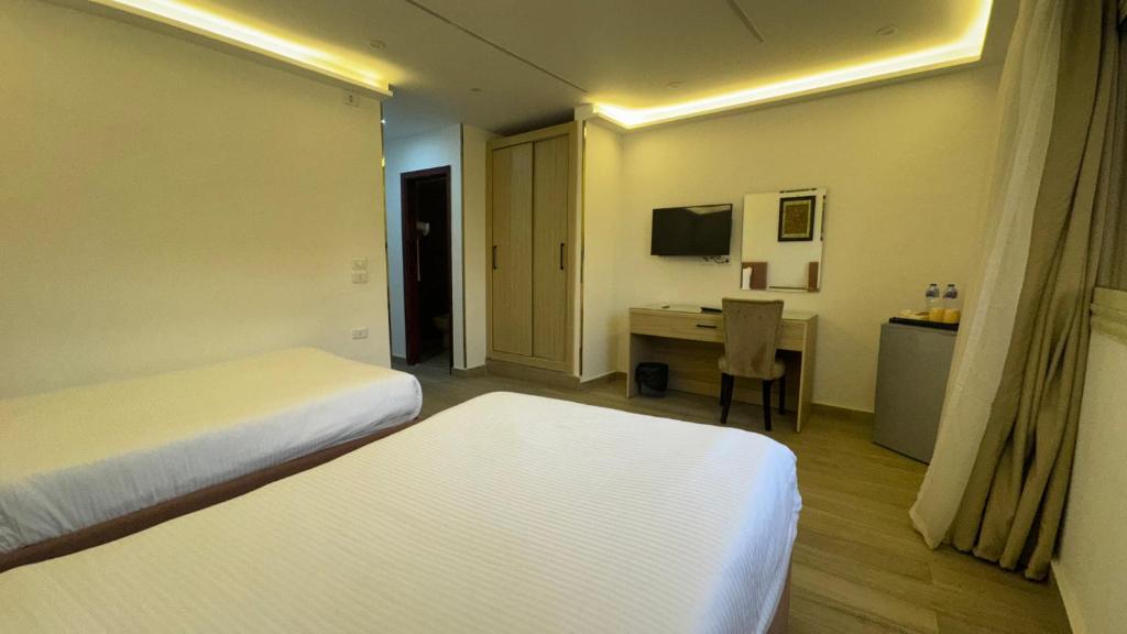 Postel nebo postele na pokoji v ubytování Pyramids Hotel