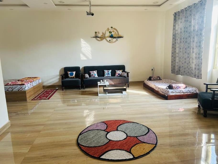 a living room with a couch and a rug on the floor at Urban Zen Oasis - Independent floor in City Centre in Gwalior