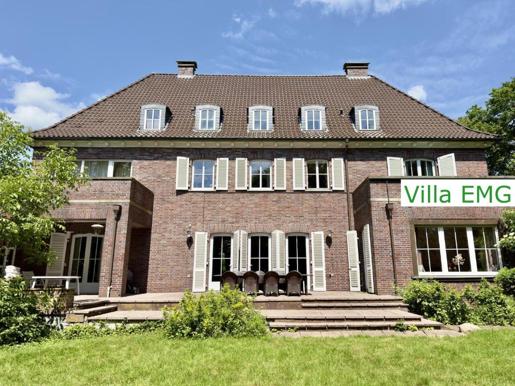 a large brick house with a sign in front of it at Luxury Villa EMG Steinfurt Münster Enschede - Steinfurt in Steinfurt