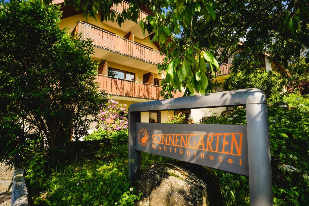 a sign in front of a building at Hotel Sonnengarten Apartments in Überlingen