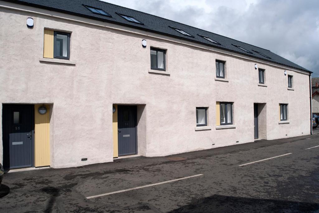 a large white building with a lot of windows at The Pyjama Factory in Bushmills