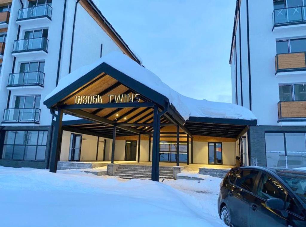 a building with a car parked in front of it at Black mamba in Gudauri