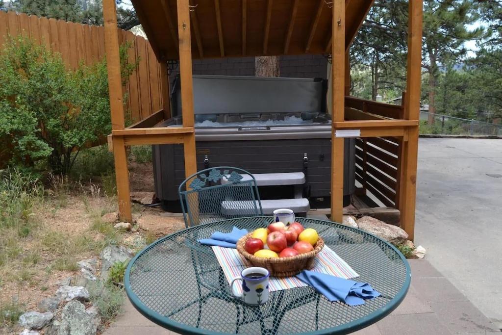 a table with a basket of apples on it in front of a grill at Bear House - EV #3073 in Estes Park