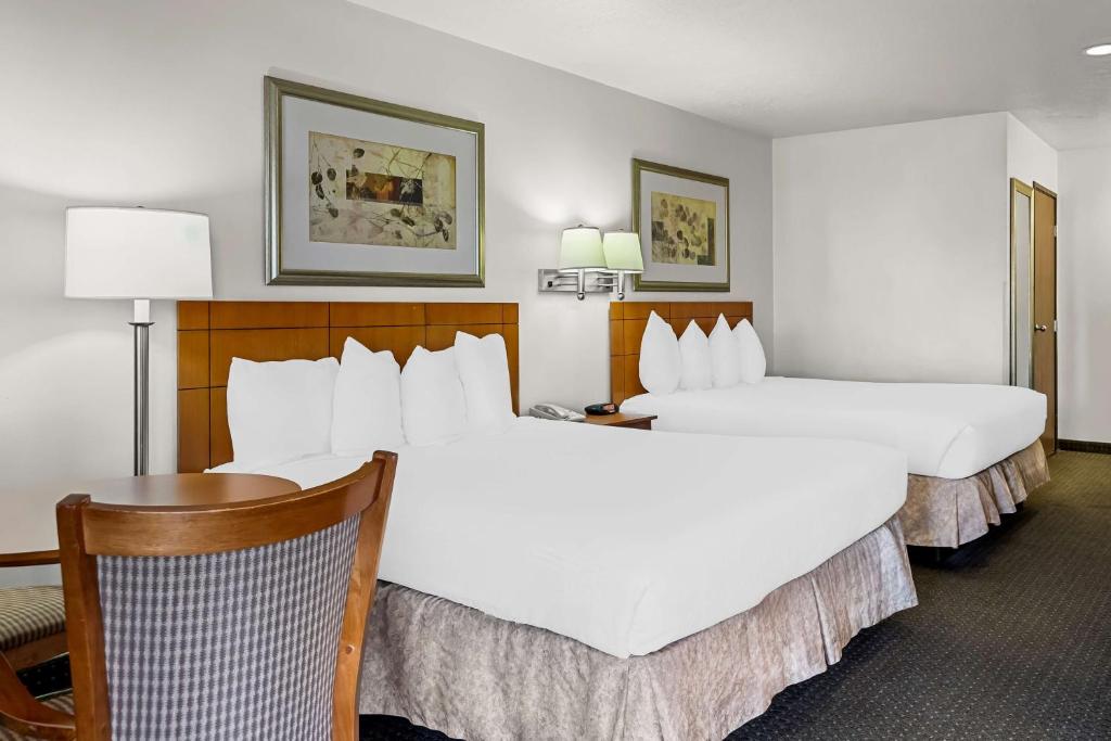 a hotel room with two beds and a table at Best Western Socorro Hotel & Suites in Socorro