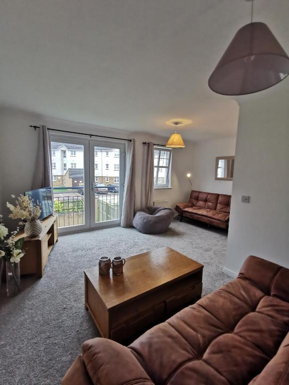 a living room with a couch and a coffee table at Sun Gardens Retreat- can sleep 10 with 4 Double Beds & 2 sofa beds in Stockton-on-Tees
