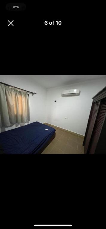 a bedroom with a blue bed and a window at Holidays home in Dahab