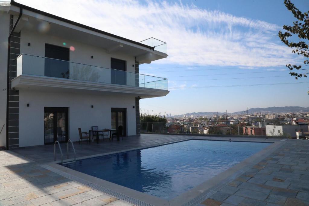 a house with a swimming pool on a roof at Garden Hill Villa Durres in Durrës
