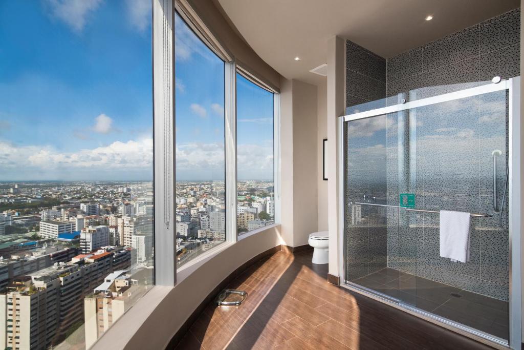 a bathroom with a view of a city at Embassy Suites by Hilton Santo Domingo in Santo Domingo