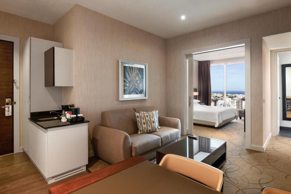 a living room with a couch and a table at Embassy Suites by Hilton Santo Domingo in Santo Domingo