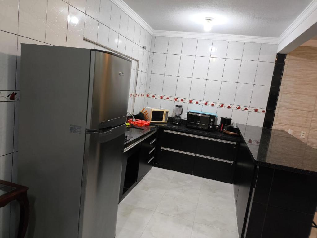 a kitchen with a stainless steel refrigerator in it at Casa de Praia Família Próximo ao ExpoCentro BC in Balneário Camboriú