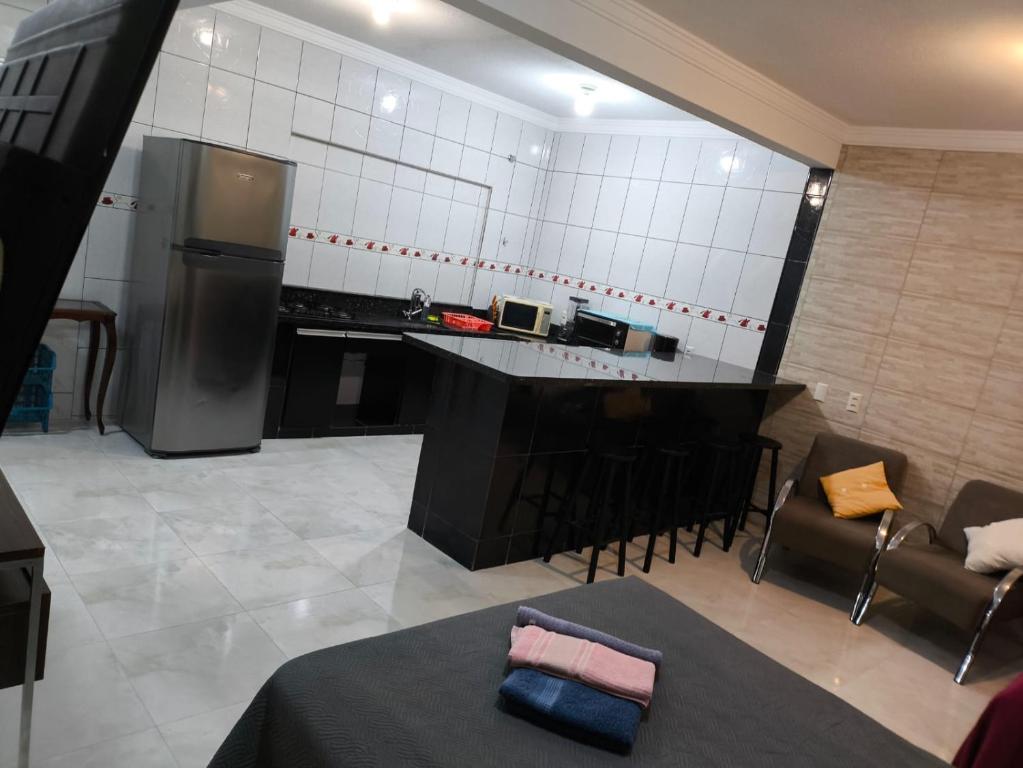 a kitchen with a refrigerator and a table and chairs at Casa de Praia Família Próximo ao ExpoCentro BC in Balneário Camboriú