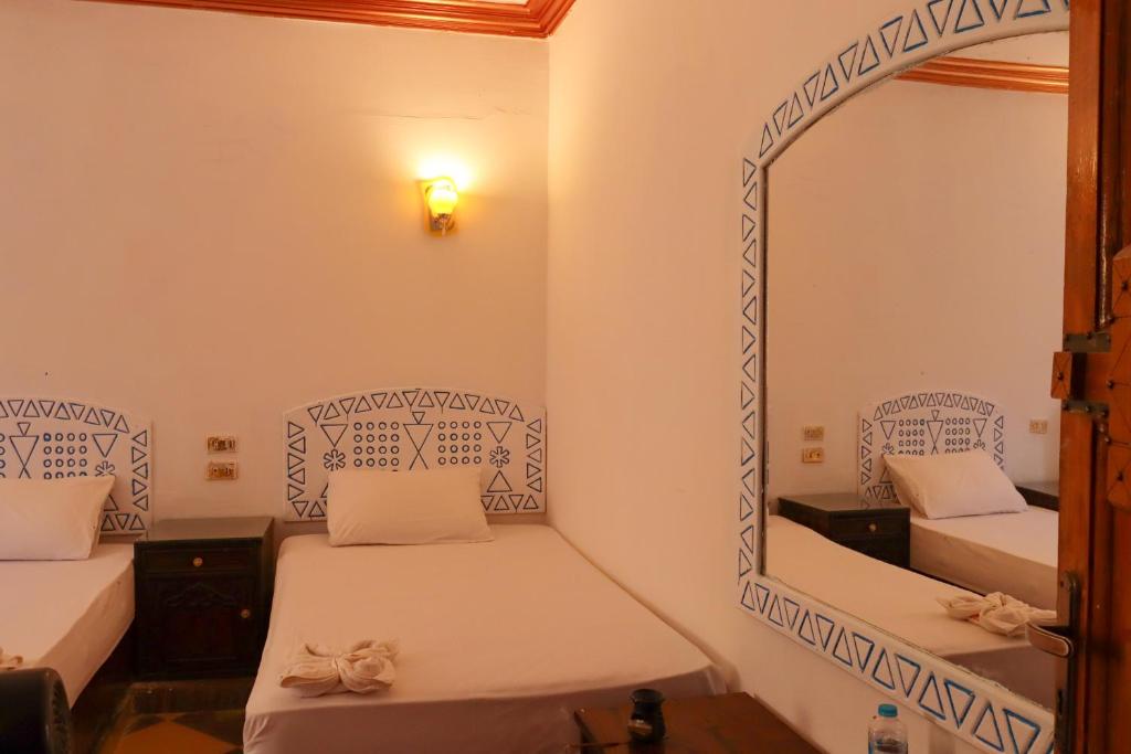 Postel nebo postele na pokoji v ubytování Nubian Kulih house