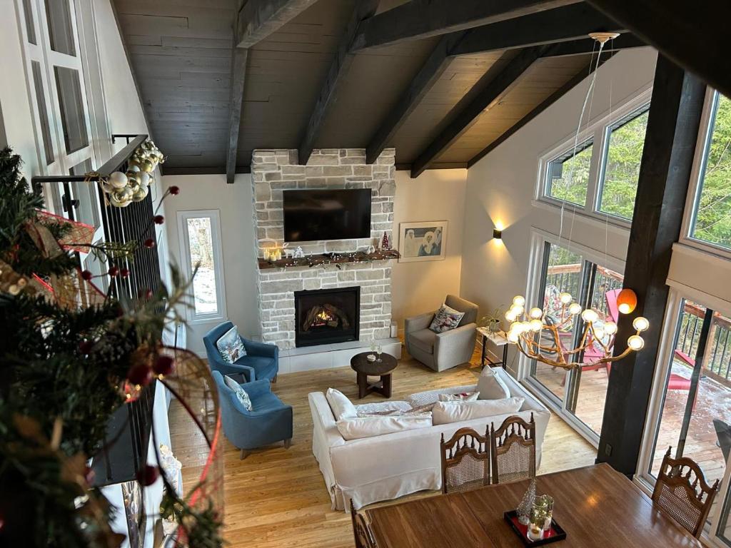 a living room with a couch and a fireplace at Cozy Chalet by the Lake - Your Perfect Escape in Hébertville