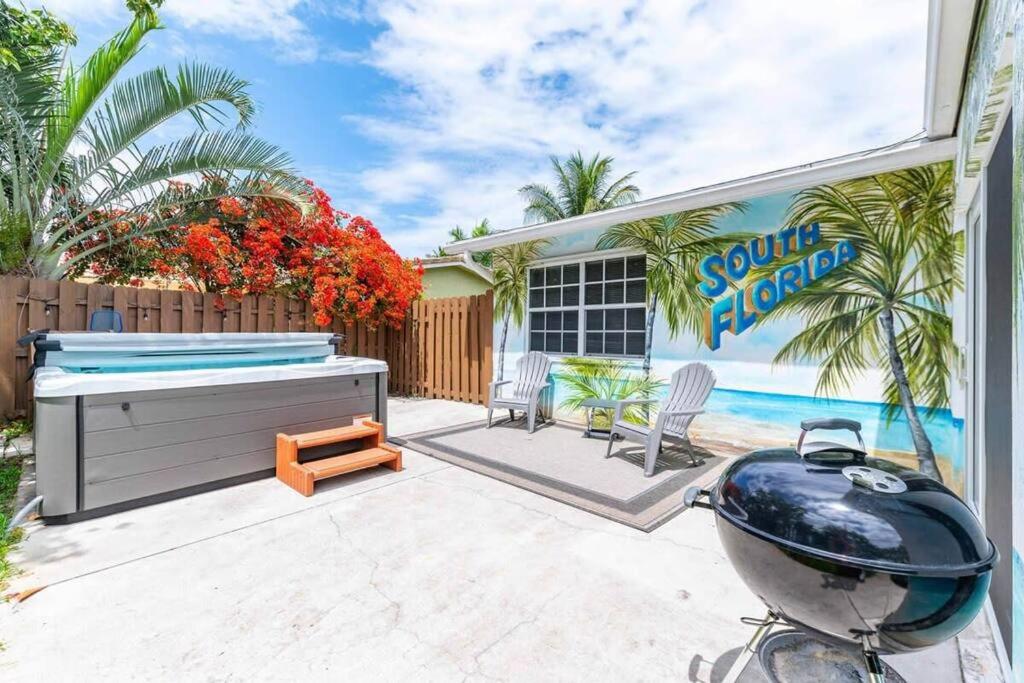 a backyard with a grill and a swimming pool at Ventur Tropical w Hot Tub Close to Beach in Deerfield Beach
