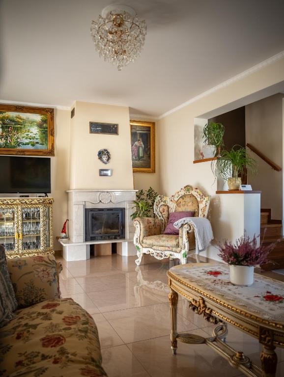 a living room with two chairs and a fireplace at Prywatny Dom z Parkingiem Trzy Sypialnie Self check-in Faktura in Rzeszów
