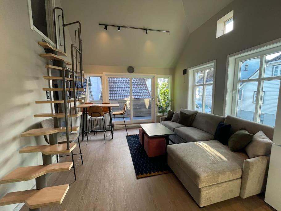 a living room with a couch and a table at Nostalgic Nook 27 by Stavanger BnB in Stavanger