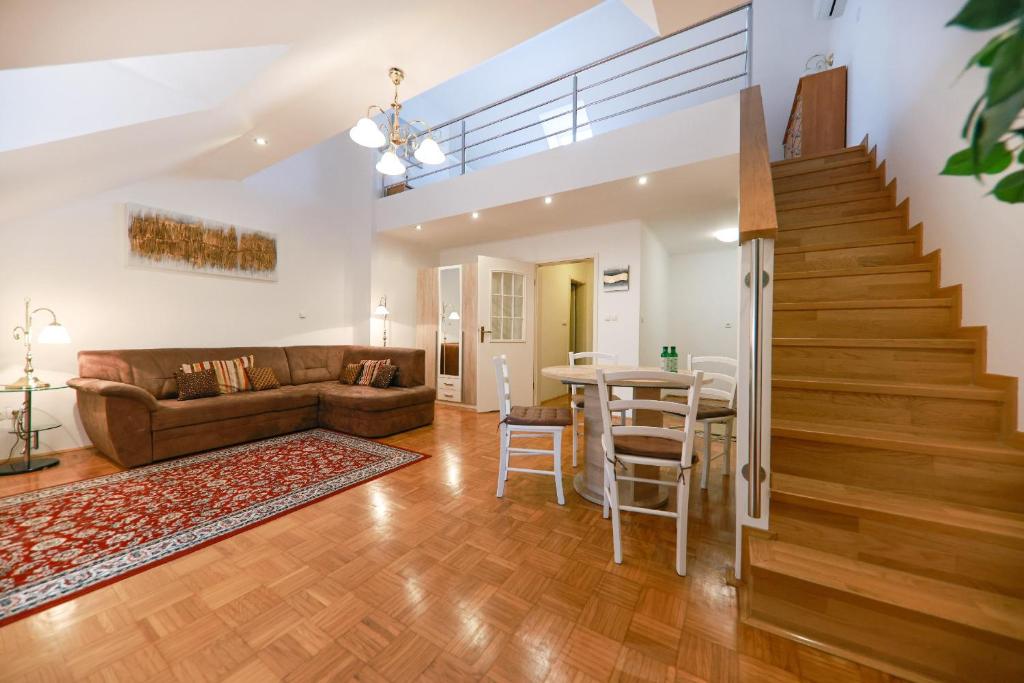 a living room with a couch and a table at Apartments at Villa Golf in Rogaška Slatina
