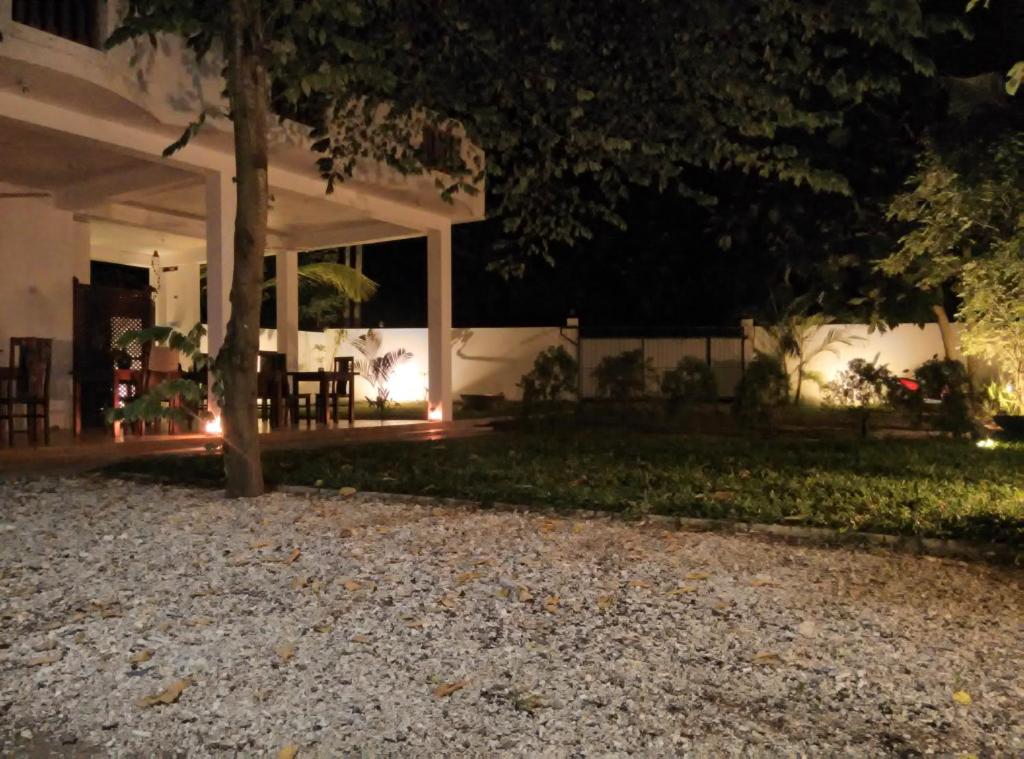 una casa por la noche con luces en el patio en Sounds of Nature mini hotel, en Mirissa