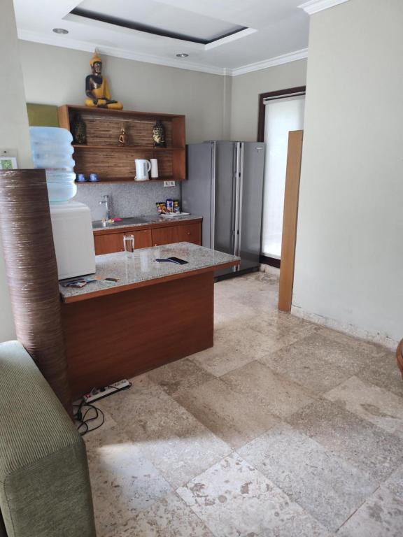a kitchen with a counter and a refrigerator at Spacious Private Pool Apartment-Beachside Resort in Candidasa
